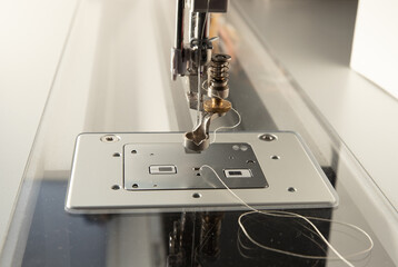 Closeup of a sewing machine presser foot. 