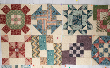 A variety of colorful quilt blocks loosely arranged to establish the final quilt design.