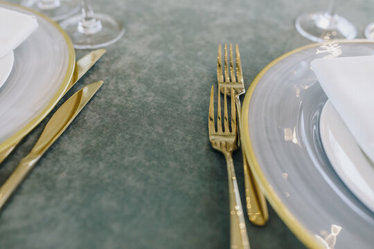 Golden cutlery on dining table 