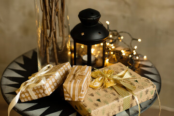 Christmas and New Year background - gift boxes near a decorated Christmas tree with garlands of lights