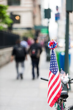 American flag on bicycle in city central street