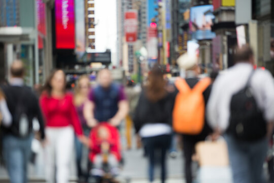 Blurred crowd of people walking on street in big city