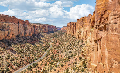 The East Burr Trail Road winding through the red rock walls of Long Canyon, Utah, USA