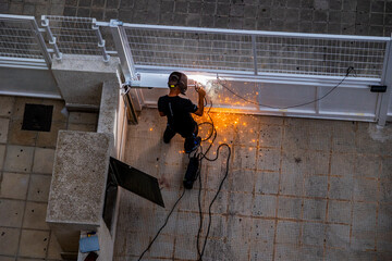 welder at work at a  metal gate top view