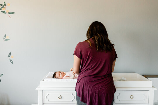 Woman Gives Infant A Diaper Change 