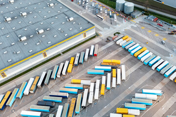 Many trucks and trailers are parked at the base, logistics and production center.