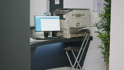 Hospital registration desk with appointment forms on computer, checkup reports and insurance papers on counter. Empty facility reception for medical consultations and examinations.