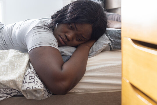 mental health, sad young woman plus size lying down on the bed, apathy