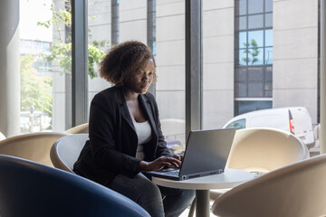 professional business woman working online on laptop computer in cafe