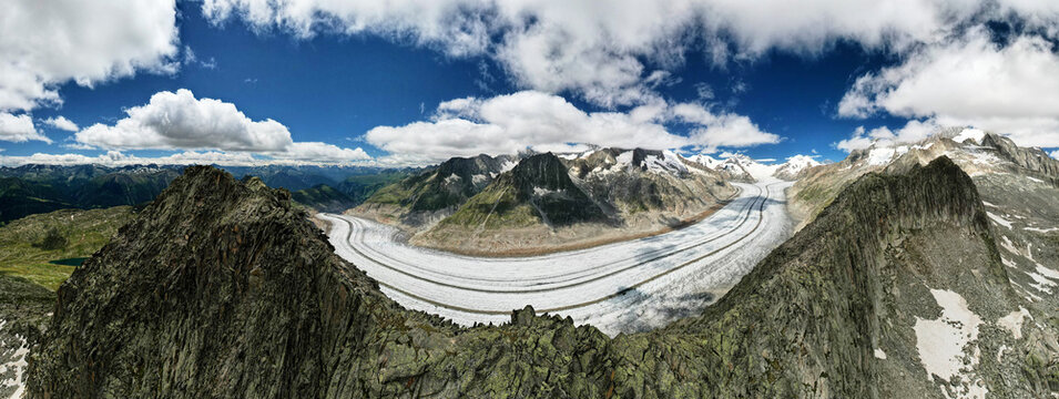 Ice of Aletsch Glacier, largest in Swiss Alps curves behind mountain