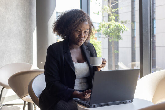 entrepreneur, business woman in cafe working online on laptop computer