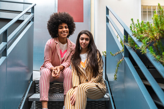 Multiracial women sharing free time in coworking space