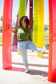 Woman stands against colorful acrylic columns