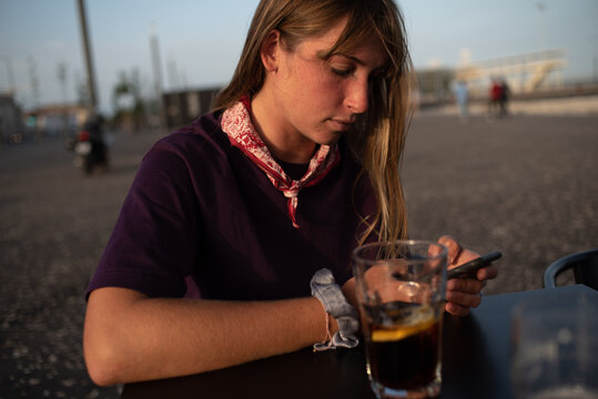 Candid Gen Z blonde on phone 