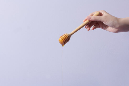 Honey dipper and fragrant honey falling