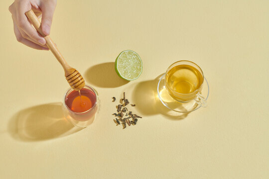 Lemon Tea And Honey Isolated On Light Yellow Background