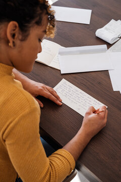 Hispanic female writing letter