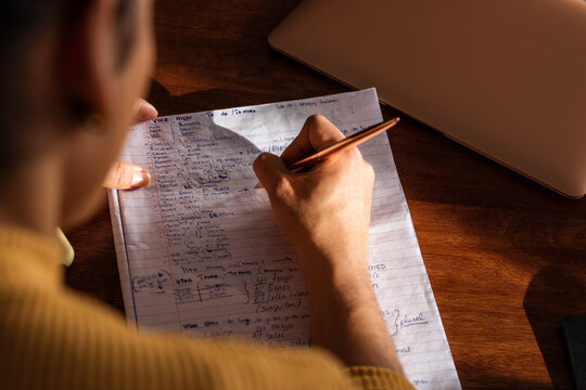 Crop woman writing down plan under sunlight - Powered by Adobe