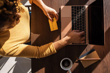 Crop female client making online payment