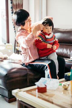 Cute little girl and grandmother at home