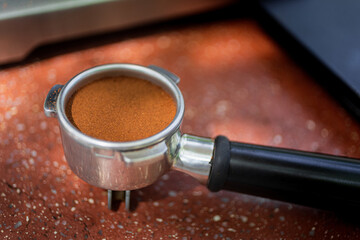 Macro closeup of tempered coffee in portafilter