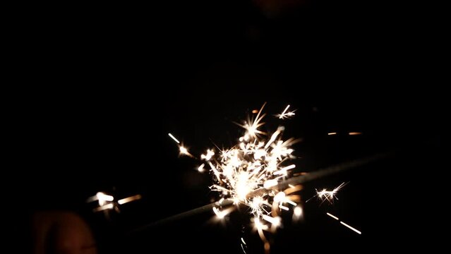Fire sparkler in the dark closeup. holiday celebration