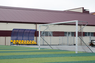Obraz premium a small green soccer field and a white gate