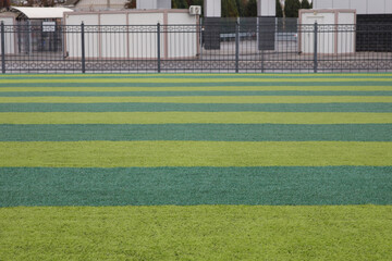 soccer field horizontal green lines, fence background