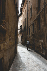 Men at a narrow street in a old town