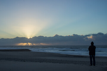 Men viewing sunset at a beach