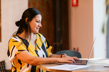 Woman using laptop in bright office