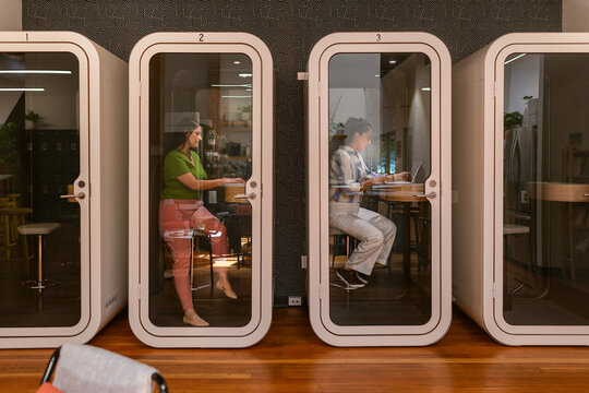 Coworkers using private cabins