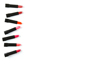 Close up shot of a single glossy lipstick isolated on white background with a lot of copy space for text.