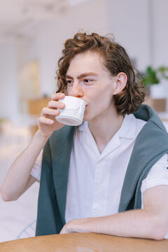 Guy take coffee break in stylish cafeteria