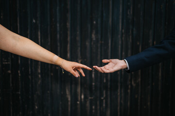 bride and groom softly touching hands