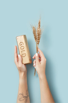 Gold and gilded wheat in woman's hands.
