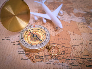 Close up of golden compass on vintage map,travel concept,road direction