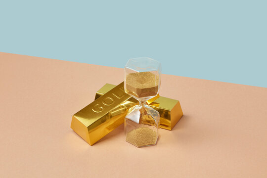 Gold ingots and stylish retro sandglass.