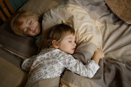 Two sleeping children in bed