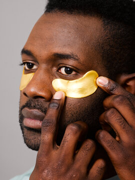 Man applying collagen eye patch