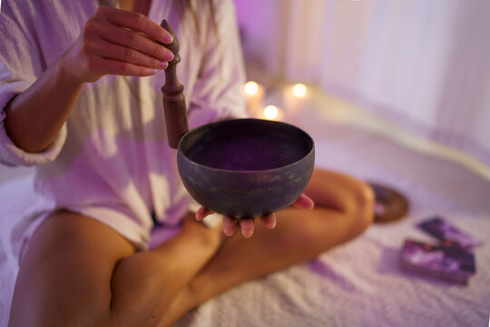 Woman creating music with singing bowl