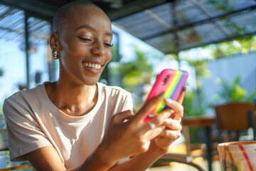Cheerful woman messaging on cell phone