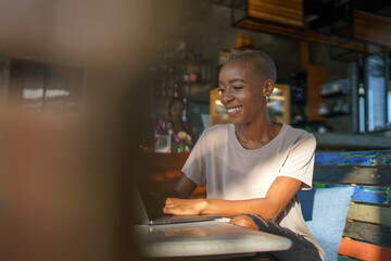 Smiling professional using laptop at cafe