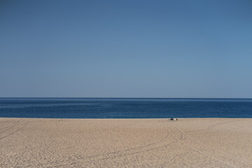 A day at the beach. Lovely colors and the sea just ahead in the village of Nazaré where the biggest waves in the world are surfed.
