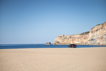 A day at the beach. Lovely colors and the sea just ahead in the village of Nazaré where the...