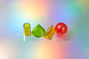 Different colorful glass geometric shapes.