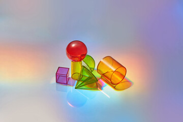 Glass geometric figures on glossy background.
