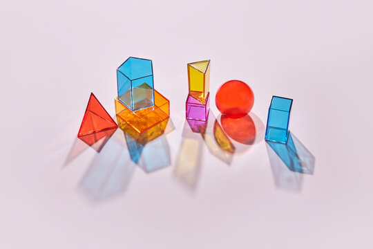 Multicolored geometric glass figures with shadow.