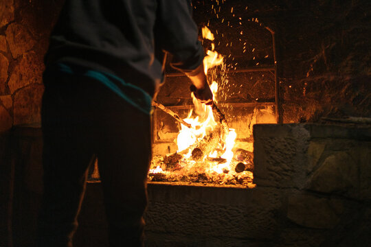 Man making a fire for a barbecue at night