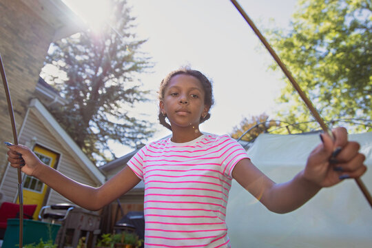 Young child helping to assemble a tent